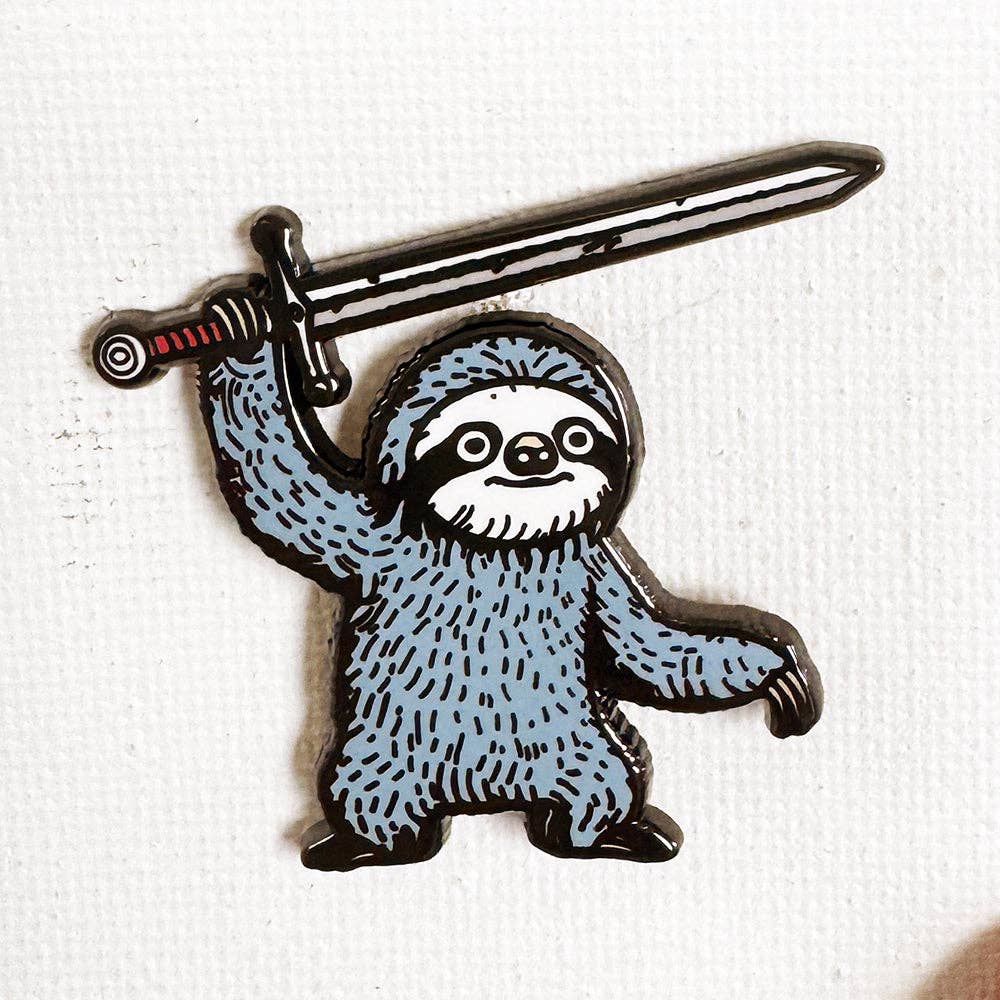 Battle Sloth 1.25-inch hard enamel pin featuring a blue sloth holding a long sword above its head.