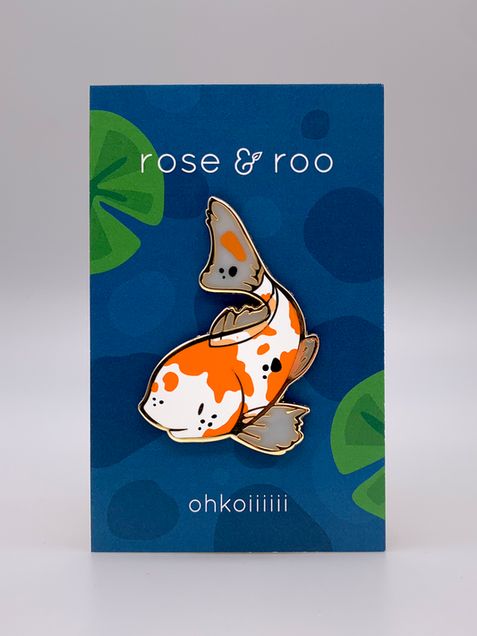 Ohkoiiiiii Fish Enamel Pin featuring a gold-plated orange and white koi, attached to a blue card with branding text.