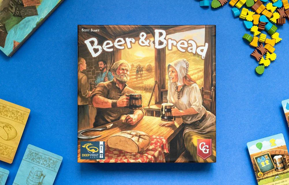 Beer & Bread two-player card game box with resource tokens and cards arranged on a blue table.