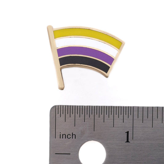 Nonbinary Flag Pin next to a ruler showing it measures approximately 1 inch wide.