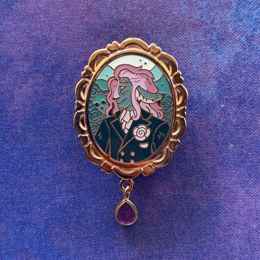 Caduceus Portrait Pin featuring a stylized figure with pink hair, suit, and roses on a blue-purple enamel background.