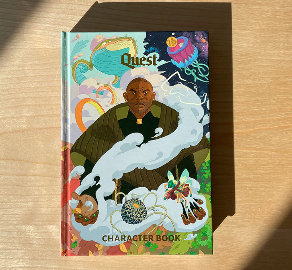 The Quest Roleplaying Character Book with full-color cover showing a serious man and magical creatures.