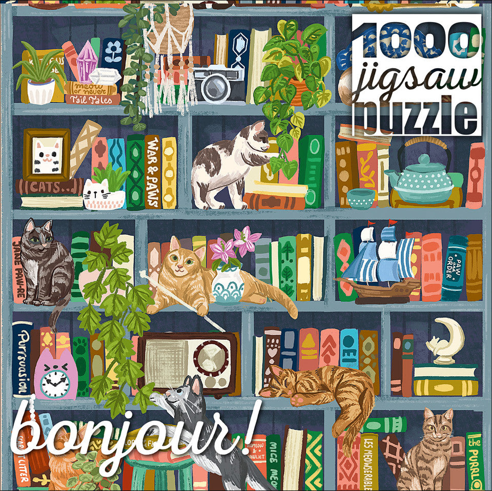 Bonjour: Cats at Home Library 1000 Piece Puzzle with bookshelf, books, plants, and cats visible nearby.