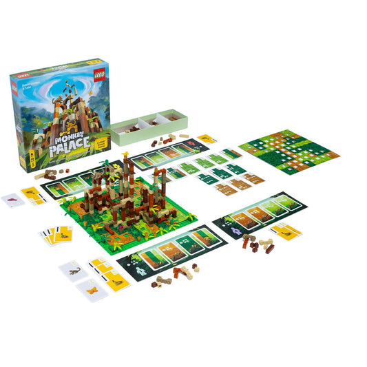 Monkey Palace board game with jungle theme, including board, cards, dice, and LEGO pieces on a white surface.