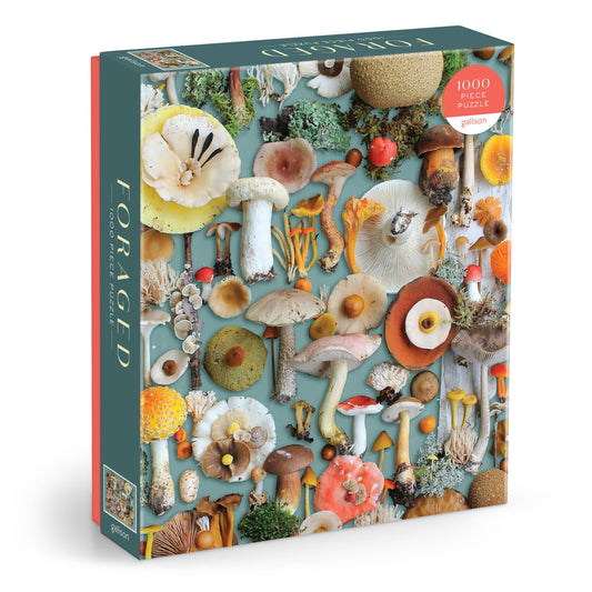 Foraged 1000 piece puzzle featuring mushrooms and plants on teal background, made from recycled paper.
