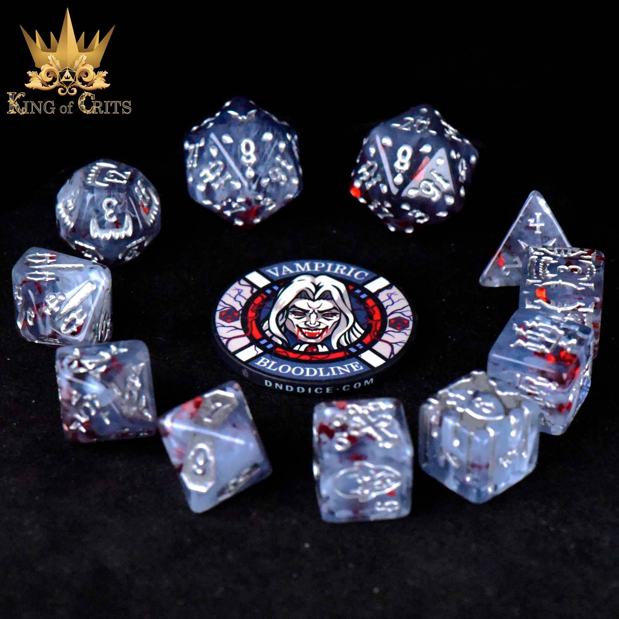 The Vampiric Bloodline 11-piece dice set is translucent with red flecks and arranged in a semicircle.