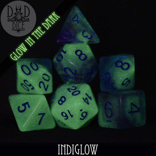 Indiglow Glow in the Dark set of 7 resin DND dice with blue numbers.
