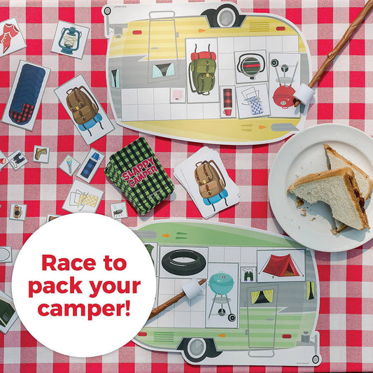Slappy Camper game with boards, cards, and item tiles arranged on a table with a sandwich plate.
