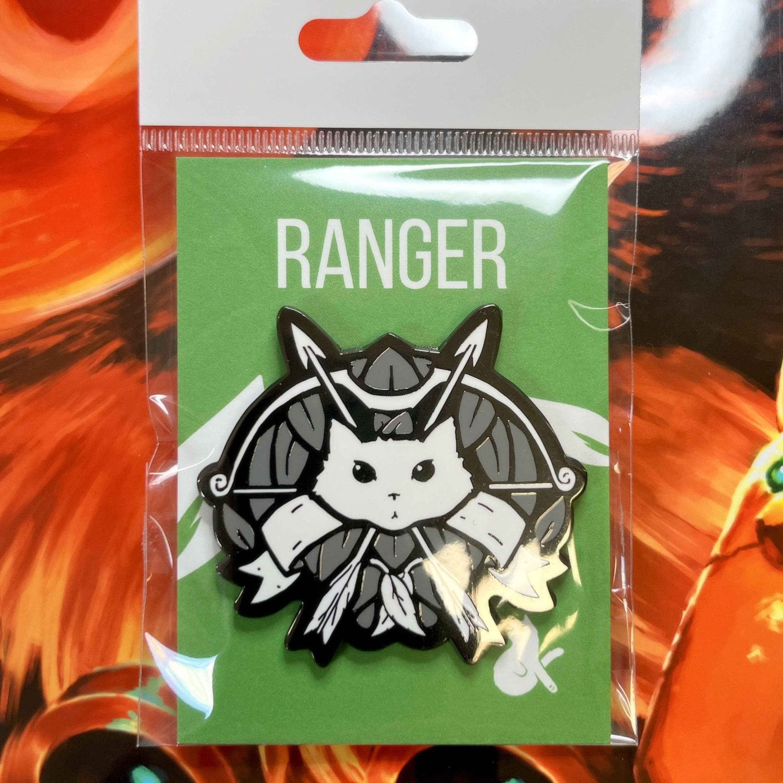 Ranger enamel pin featuring a white cat face with arrows and leaves, displayed on green backing in clear packaging.