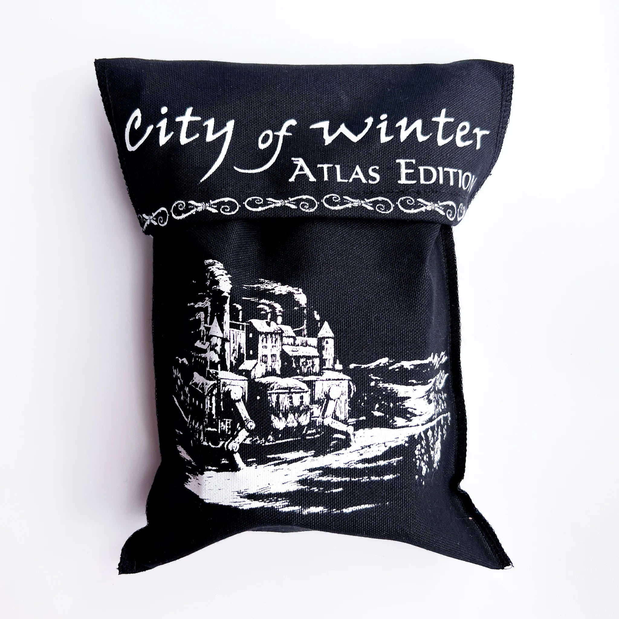 Black pouch labeled City of Winter: Atlas Edition with a castle illustration.