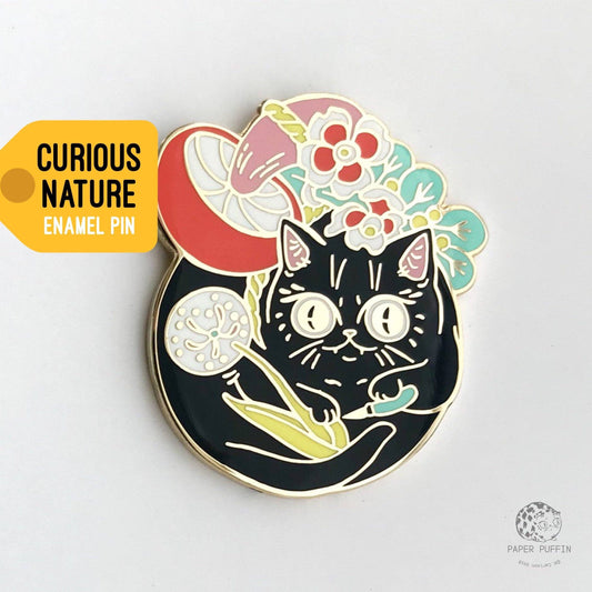 Curious Nature Cat enamel pin featuring a black cat, dandelion, mushrooms, and flowers.