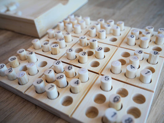 Ecologicals Bamboo Sudoku board game with numbered pegs on a wooden table.