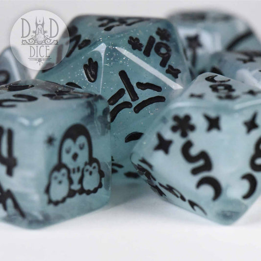 Penguin Pals 7-dice set in blue resin with black penguins and star designs.
