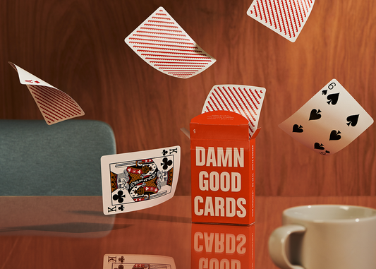 Damn Good Cards, No. 5, in an open box with loose poker-size playing cards.