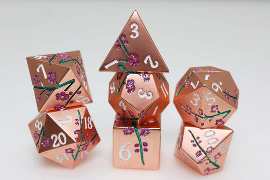 Metallic Bouquet: Copper Cherry Blossoms metal RPG dice set with white numbers on a white surface.