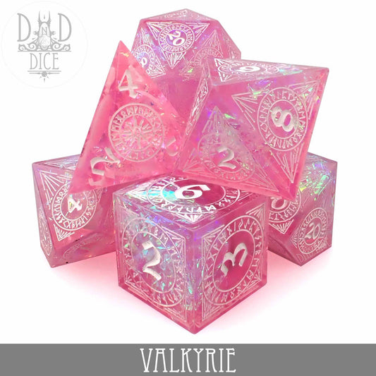 Valkyrie Handmade set of 7 pink iridescent resin dice with white numbers and decorative designs.