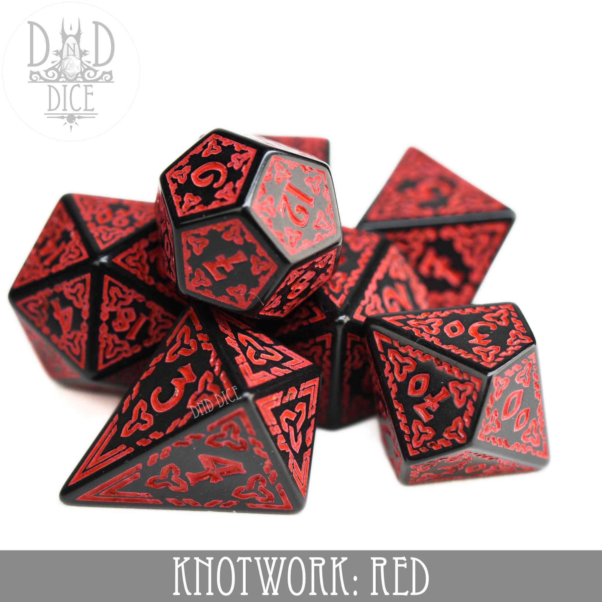 Red and black acrylic dice set with red knotwork designs, including a teardrop-shaped D4.