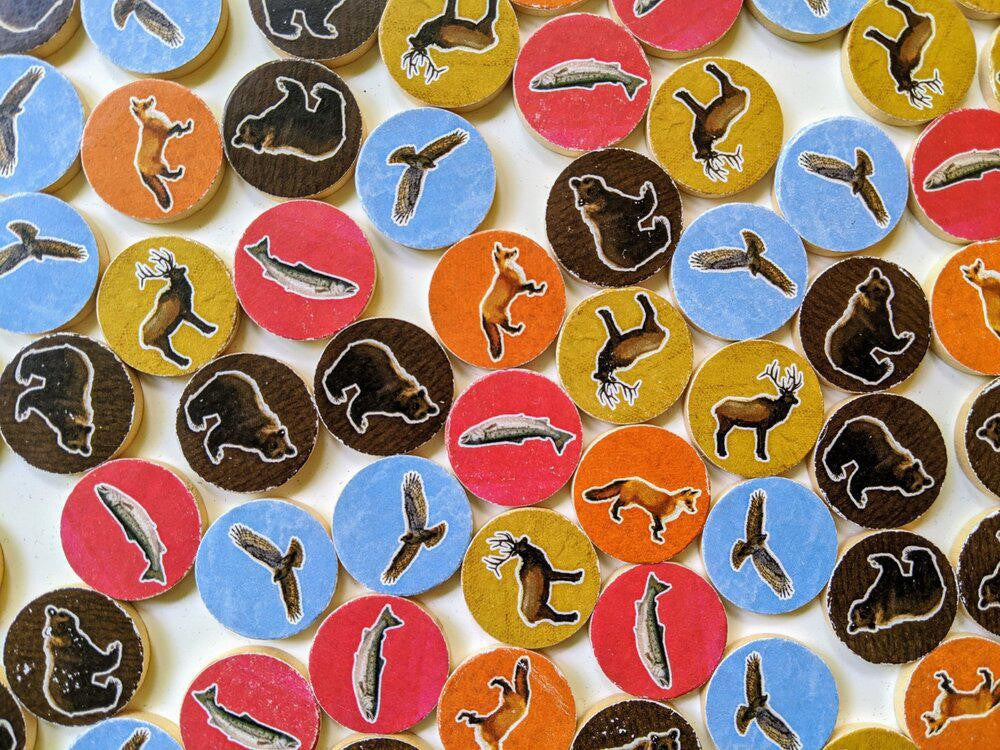 Round tokens with Pacific Northwest wildlife designs for Cascadia board game.