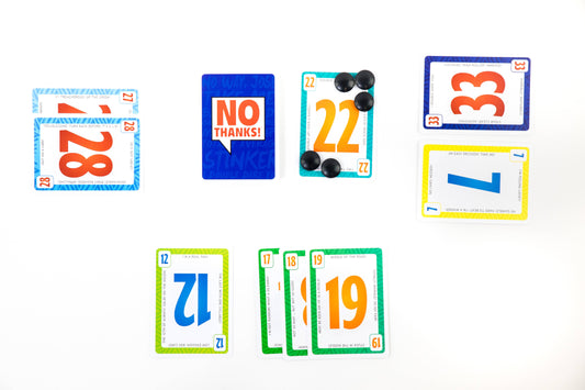 No Thanks Family Strategy Card Game with cards, chips, and deck.