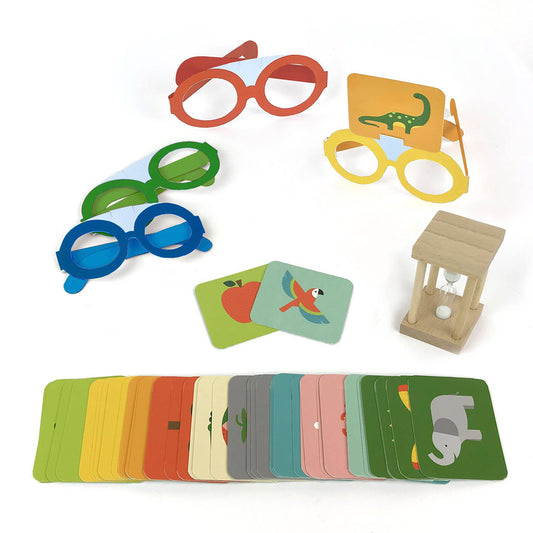 The What Am I Game set with colorful cards, hourglass timer, and three glasses.