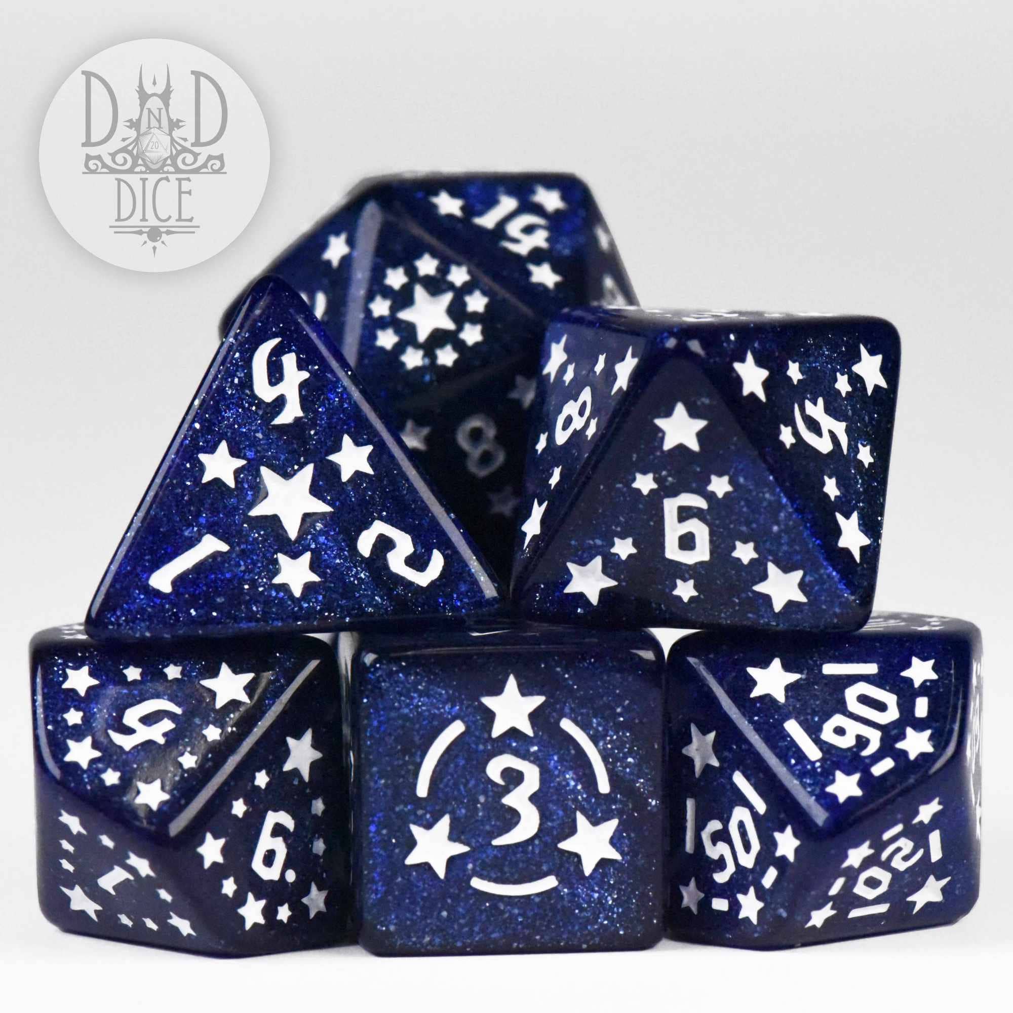 Dark blue glittery resin polyhedral dice with white stars and numbers.