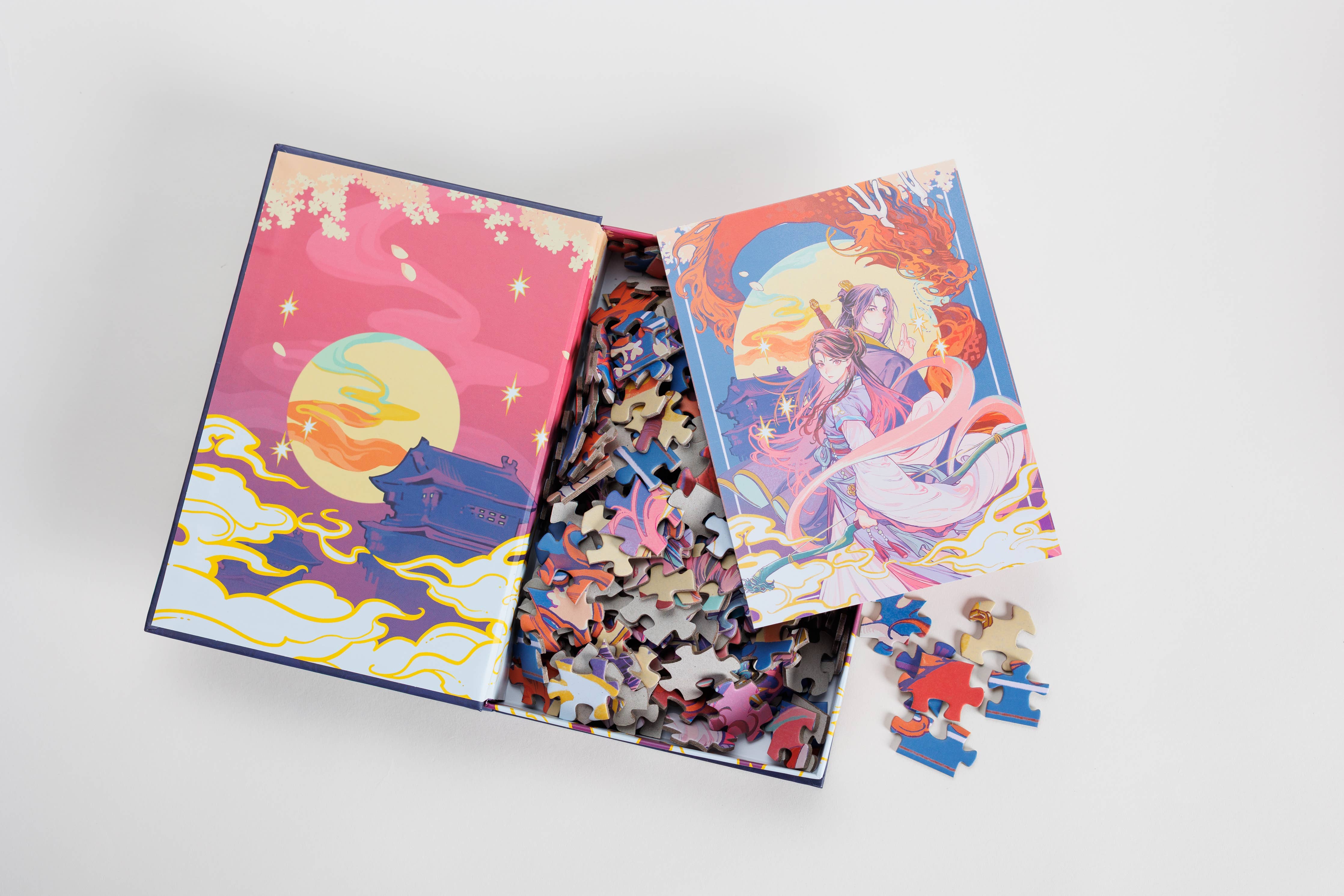 Daughter of the Moon Goddess Keepsake Puzzle shown open with illustrated guide placed next to the puzzle pieces.