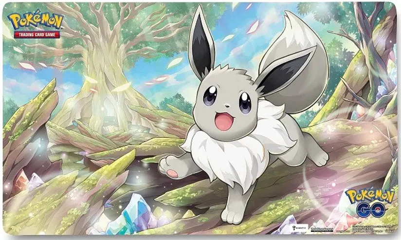 Radiant Eevee Pokemon Playmat Gift Set featuring Radiant Eevee with a crystal forest background.