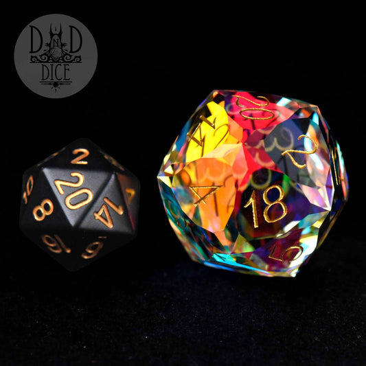 Gem Cut Prism 30mm D20 die with gold numbers in a matte black and glass gift box.