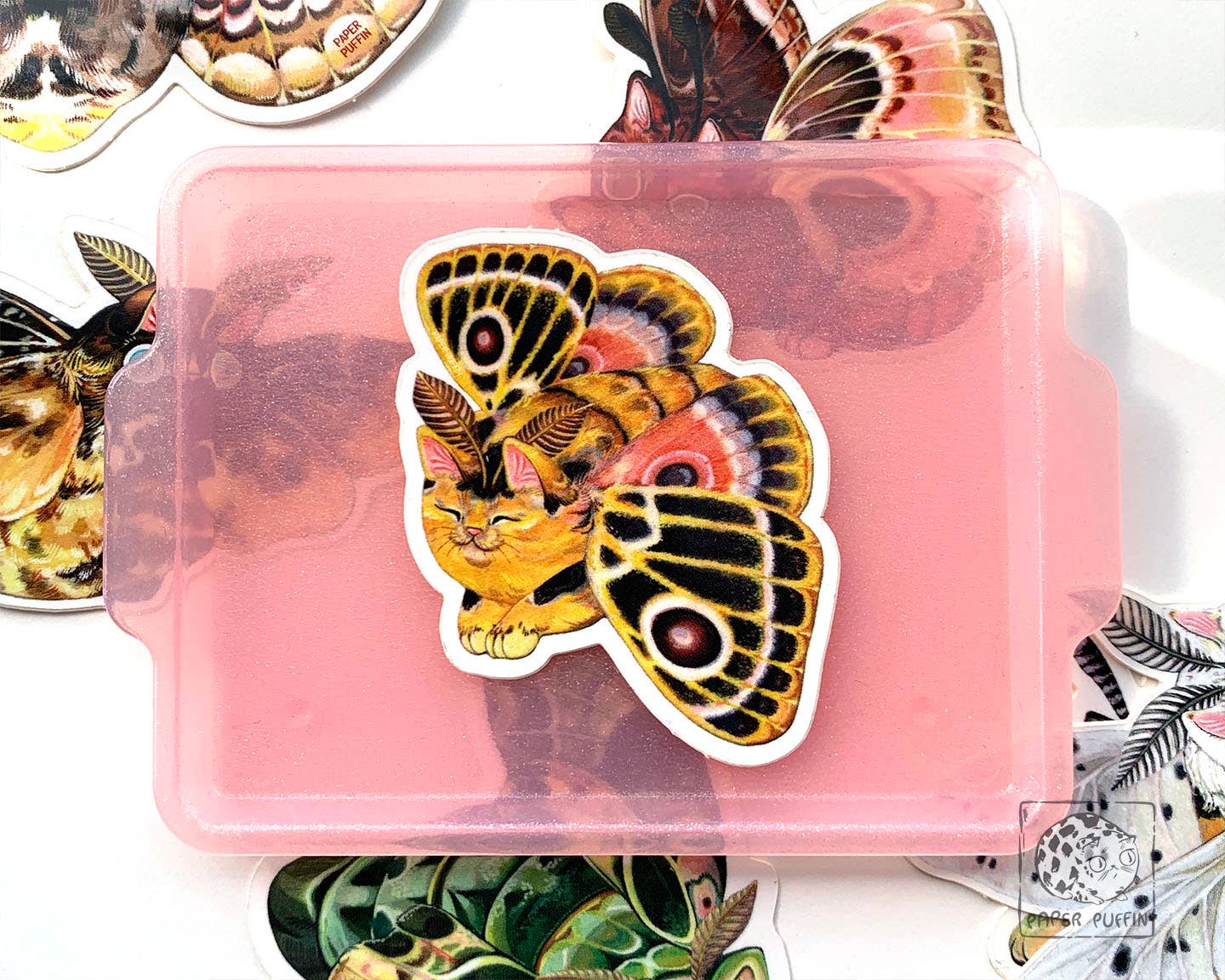 Moth Cat Vivid Joy sticker featuring a ginger cat with large moth wings.