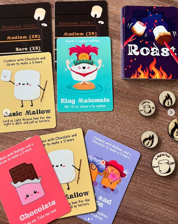 Roast board game with illustrated marshmallow cards, tokens, and a campfire-themed deck.