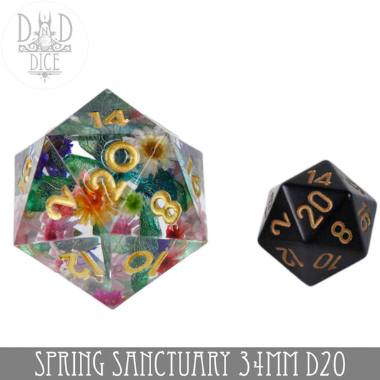Spring Sanctuary 34mm D20 with floral design next to a small black D20, both featuring sharp gold numbers.