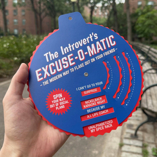 A hand holds The Introverts Excuse-o-Matic, a spinner displaying various humorous excuses.