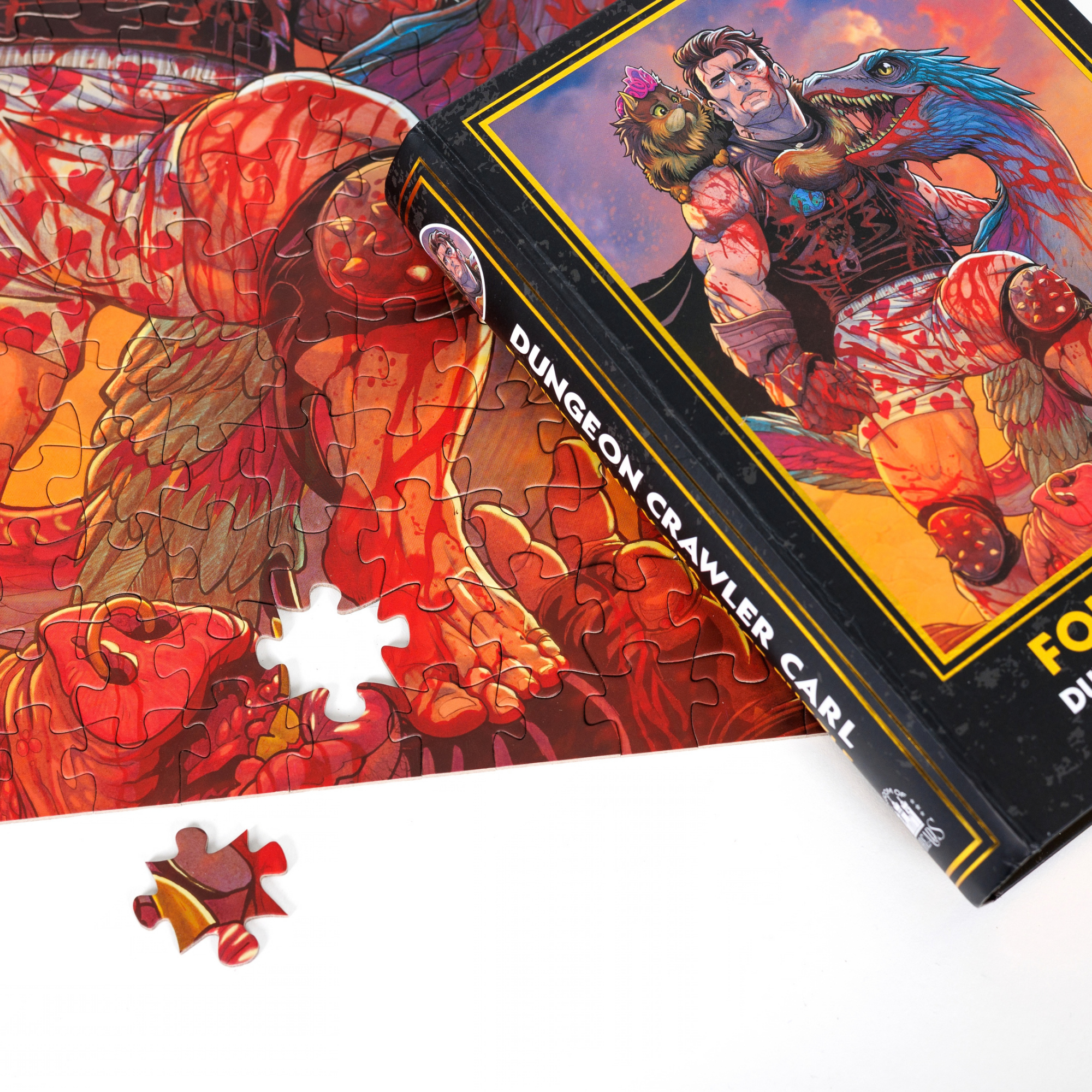 A Found Family Keepsake Puzzle | Dungeon Crawler Carl, nearly completed with one piece missing, shown next to the book.