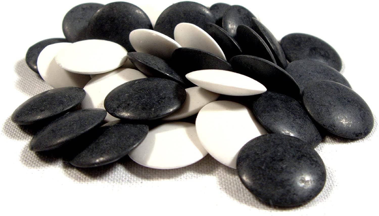 Black and white stones for 12-inch Wooden GO Game arranged on a white surface.