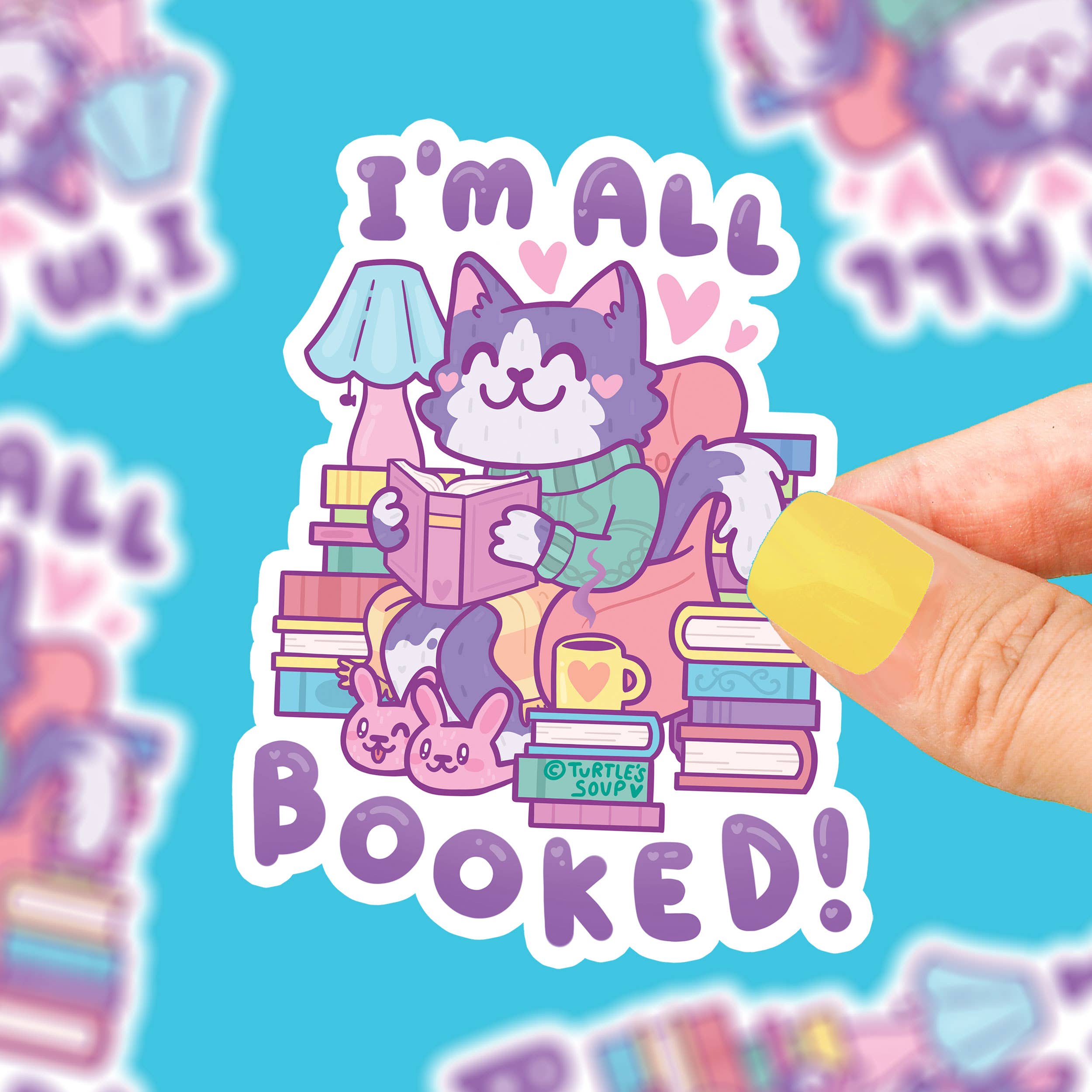 Im All Booked Up vinyl sticker with cat, couch, books, and mug illustration.