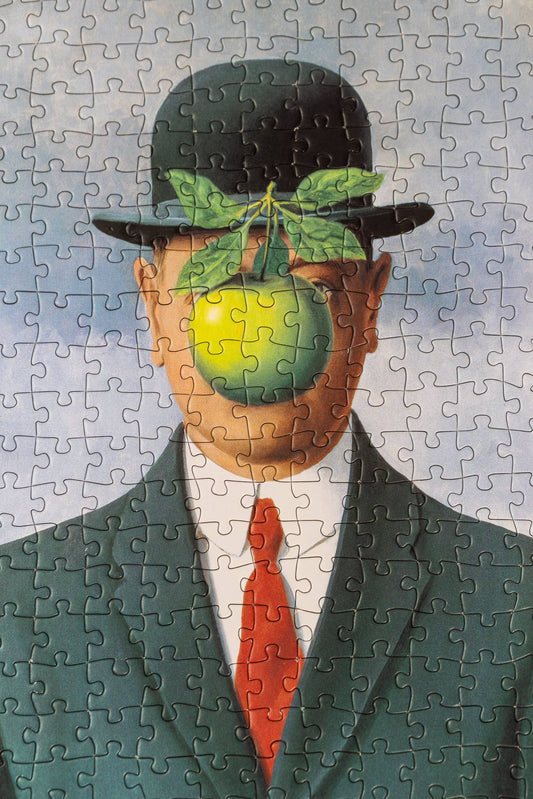René Magritte Son of Man 1000-piece puzzle featuring man in suit, bowler hat, and green apple covering his face.
