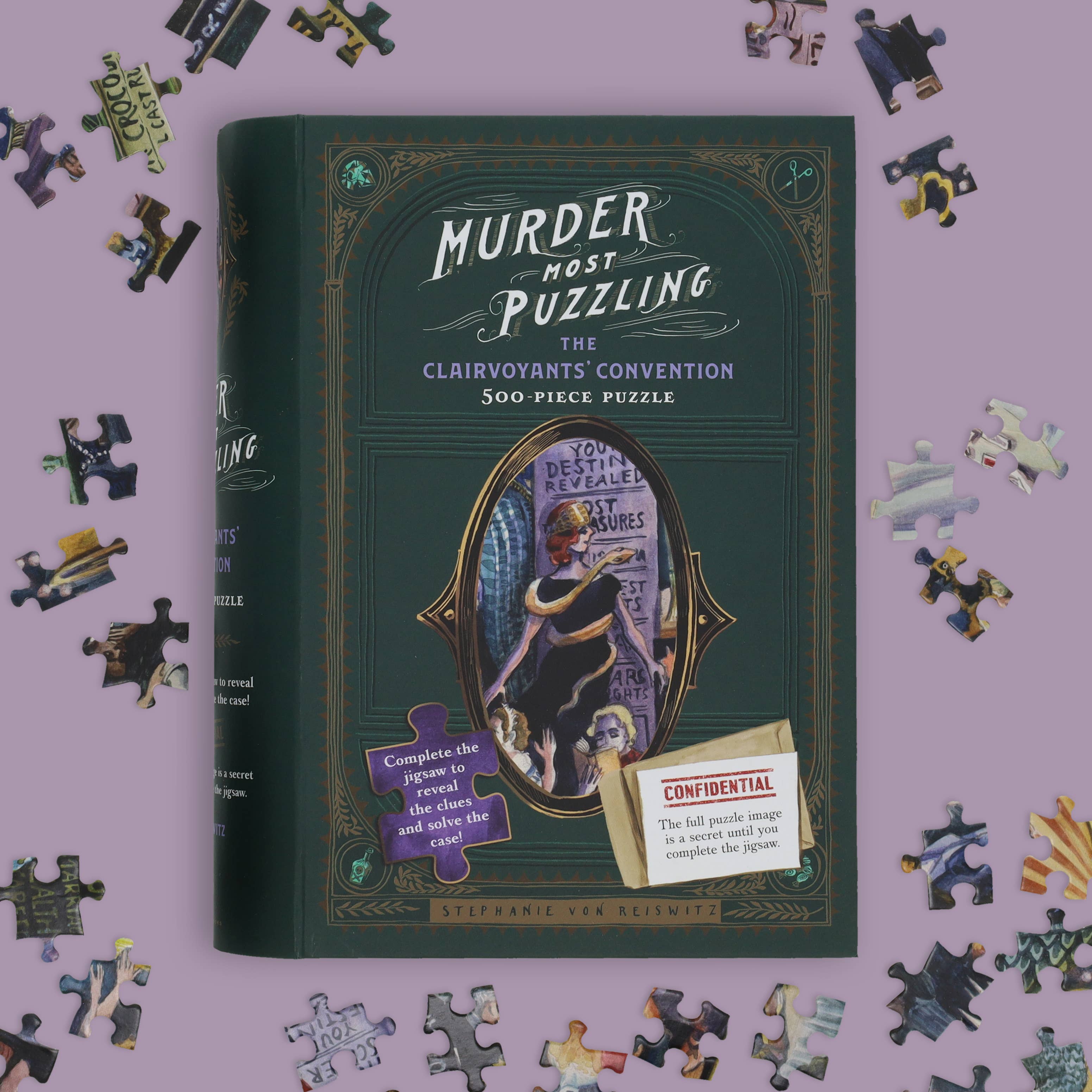 Murder Most Puzzling: The Clairvoyants Convention 500-piece puzzle box with scattered puzzle pieces.