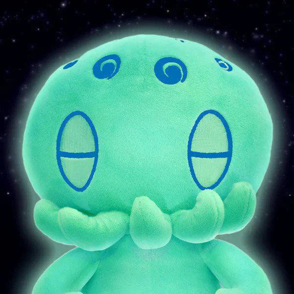 C is for Cthulhu GLOW-IN-THE-DARK Plush, teal with blue markings, glowing against a black starry background.