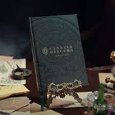 Candela Obscura Core Book, black cover, displayed upright on a gold book stand.