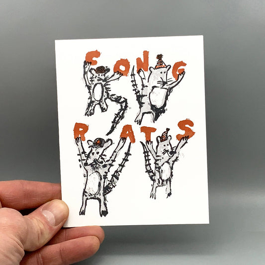 Congrats Rats card featuring four cartoon rats in party hats forming the word CONGRATS with their arms and legs.