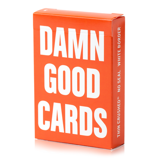 Orange Damn Good Cards, No. 5 poker-size playing cards with white text.