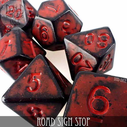 Red and black 7-piece acrylic dice set for DND, numbered, with Road Sign Stop label on the bottom.