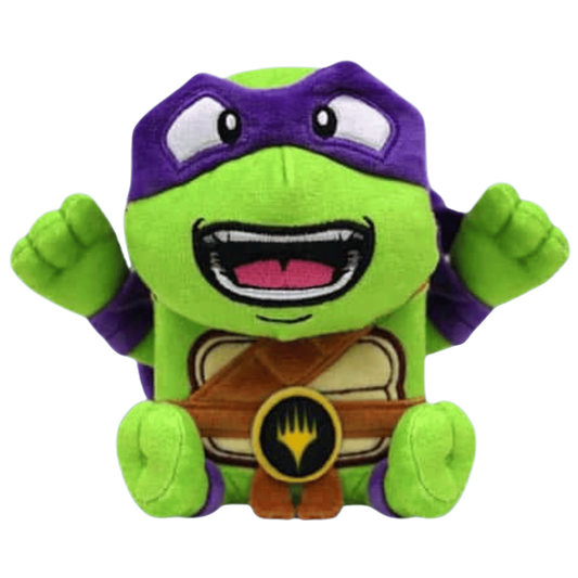 MTG ARTY Deck Box – Donatello variant held by a green plush turtle with a purple mask.