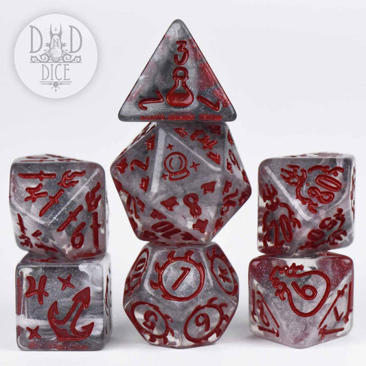 Set of six red and silver resin polyhedral dice with unique symbols, stacked on a white surface.
