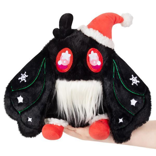 Mini Squishable Holiday Baby Mothman plush with black fur, red eyes, and a Santa hat.