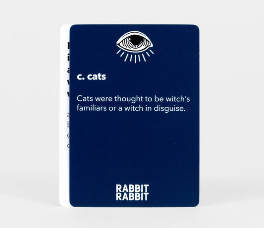 Rabbit Rabbit: A Game of Superstitions dark blue card printed with c. cats—once believed to be witches familiars.
