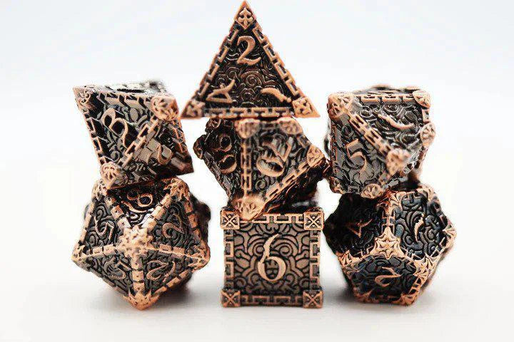Dagger of Venom Copper RPG metal dice set by Foam Brain Games, detailed designs on a white background.