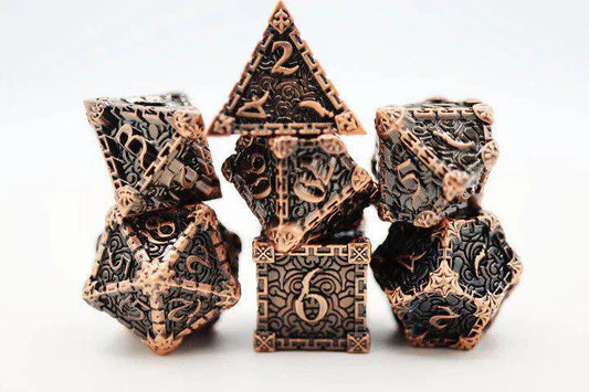 Dagger of Venom Copper RPG metal dice set by Foam Brain Games, detailed designs on a white background.