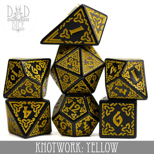 Seven black and yellow Knotwork yellow acrylic dice, including teardrop D4, in front of a DnD Dice logo.