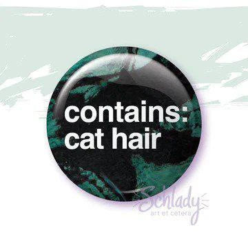 1.25 round button pin, dark green/black, with contains: cat hair in white text.